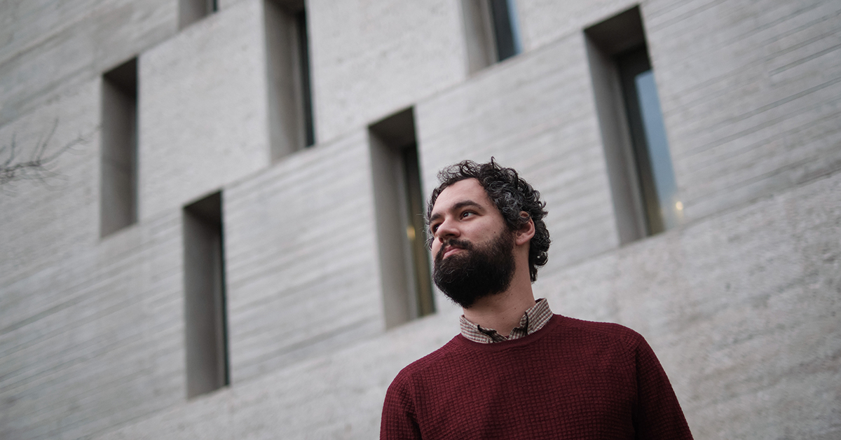 Researcher standing in front of a building